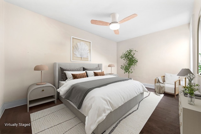 bedroom featuring a ceiling fan, wood finished floors, and baseboards