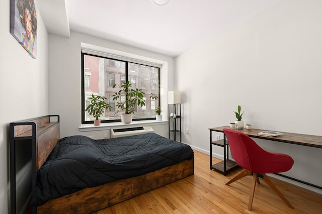 5 W 127th St Unit 2-A, New York City, NY 10027 - bedroom featuring light wood finished floors, an office area, baseboards, and an AC wall unit