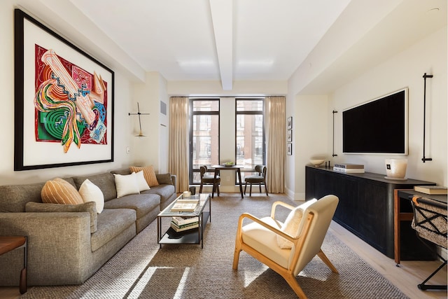 living area featuring beamed ceiling