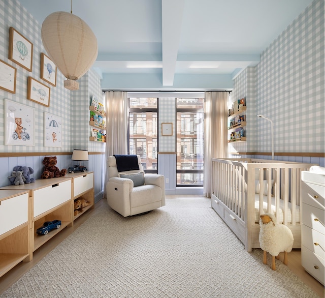 bedroom featuring carpet flooring, beamed ceiling, and wallpapered walls