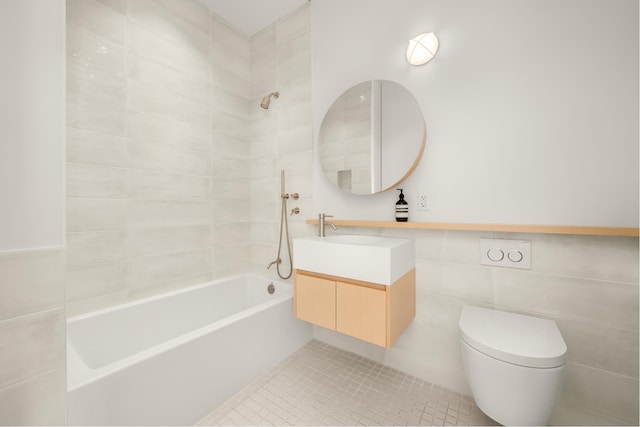 full bathroom with tile walls, shower / bath combination, toilet, vanity, and tile patterned floors