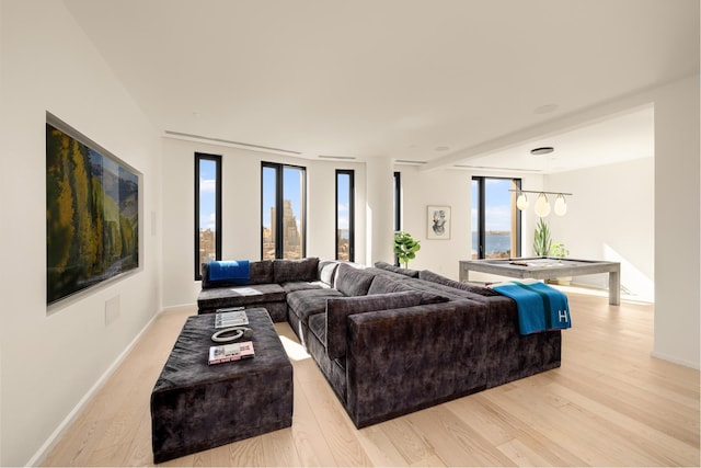 living room featuring light wood-style flooring and baseboards