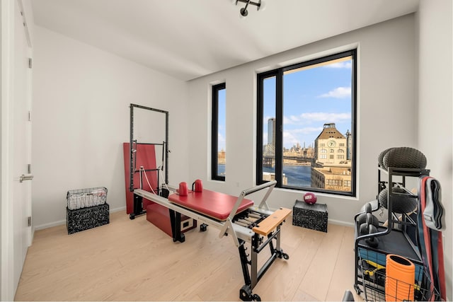 30 Front St Unit 21A/D, New York City, NY 11201 - kitchen with a breakfast bar area, open shelves, light wood-style floors, a center island, and modern cabinets