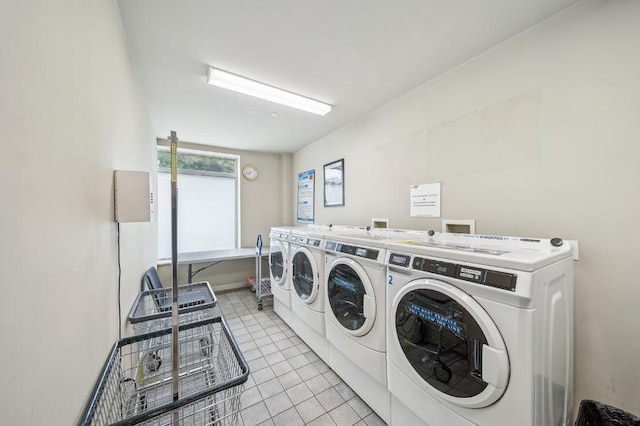 common laundry area with light tile patterned flooring and separate washer and dryer