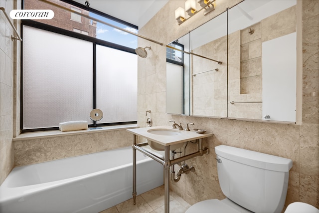 full bathroom featuring a tub to relax in, tile patterned flooring, tile walls, and toilet