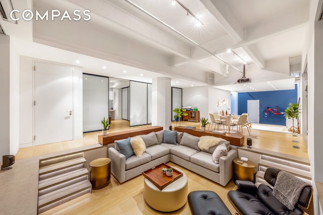 sunken living room with recessed lighting, beamed ceiling, light wood-style floors, and track lighting