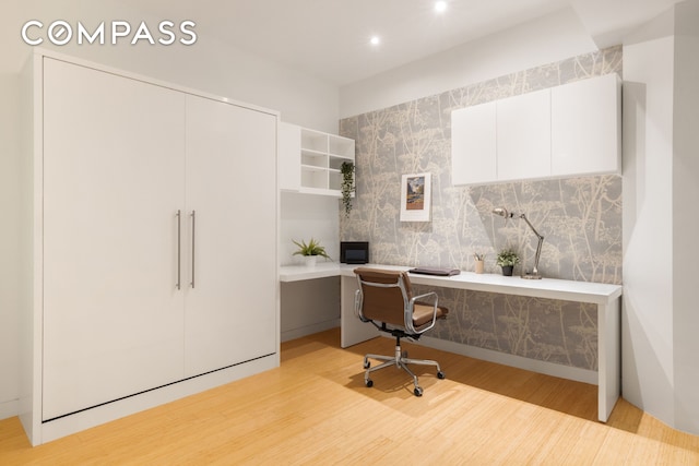 office area with built in desk, recessed lighting, and light wood-style floors