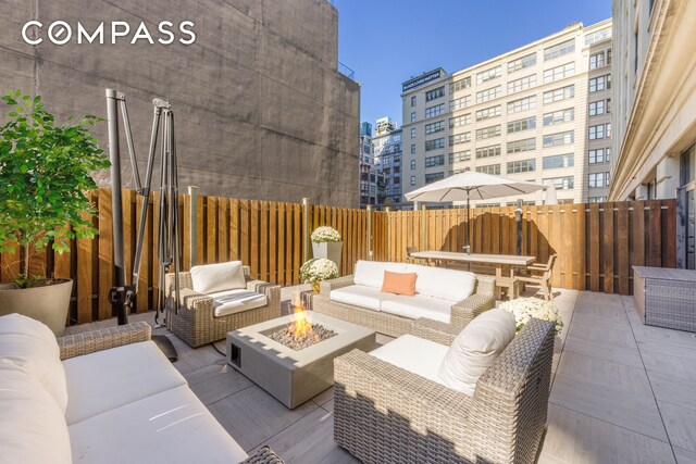70 Washington St Unit 2K, New York City, NY 11201 - view of patio / terrace with an outdoor living space with a fire pit, fence, and a city view