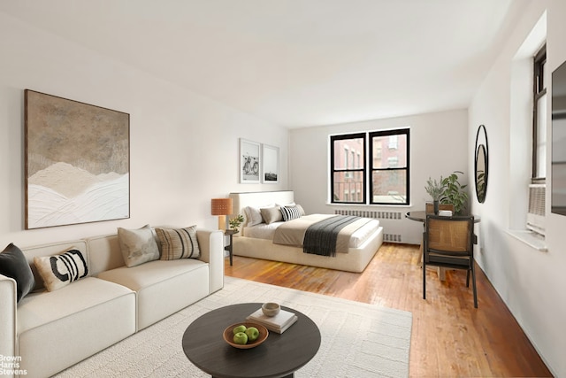 bedroom featuring hardwood / wood-style flooring and radiator heating unit