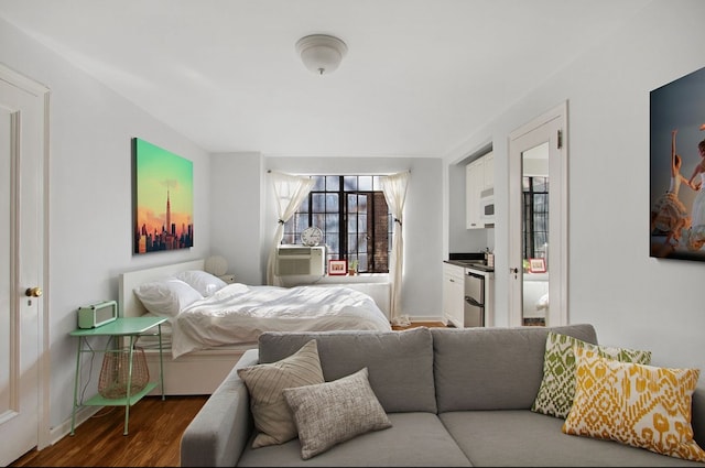 bedroom with dark wood-type flooring, cooling unit, and baseboards