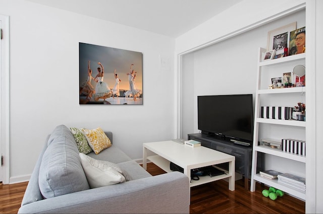 living room with baseboards and wood finished floors