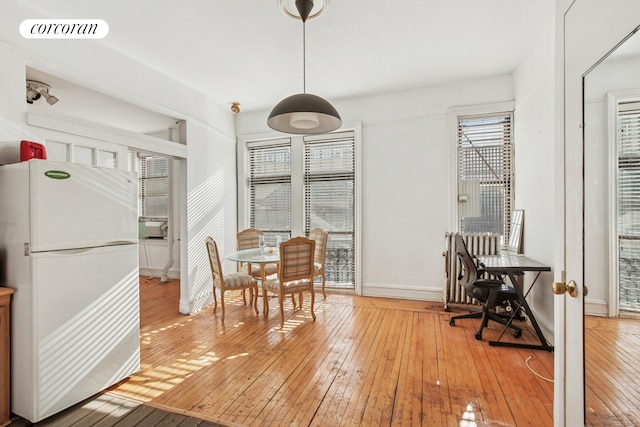 dining room featuring baseboards, visible vents, and light wood finished floors