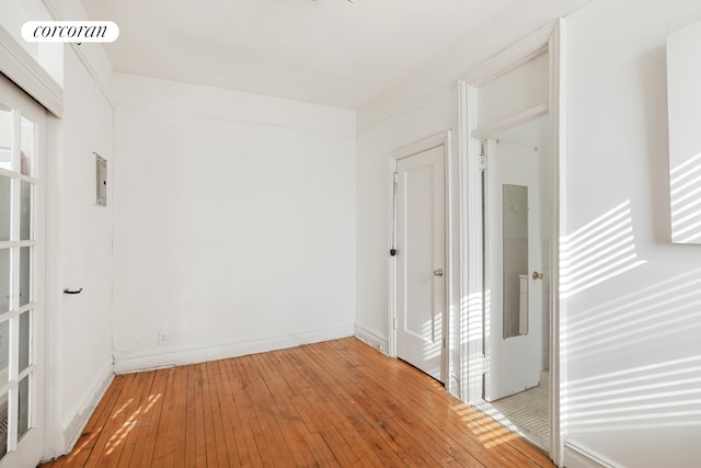 unfurnished room with visible vents, light wood-type flooring, and baseboards