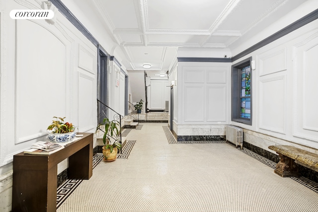 hallway featuring visible vents, coffered ceiling, and radiator heating unit