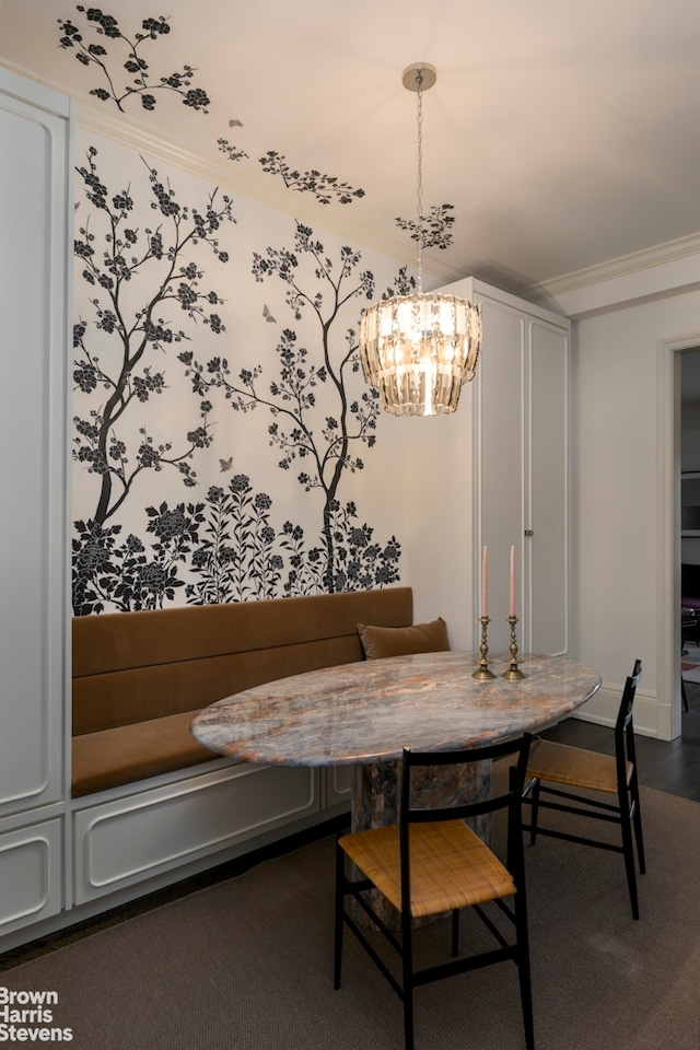 dining space with a notable chandelier, breakfast area, and crown molding