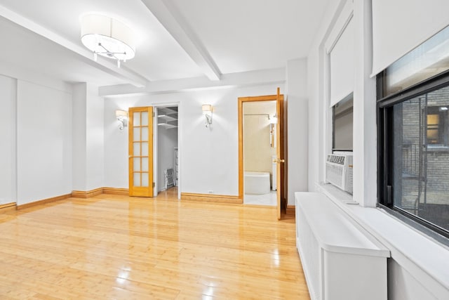 321 E 54th St Unit 2J, New York City, NY 10022 - unfurnished room with beamed ceiling, baseboards, light wood-type flooring, and cooling unit
