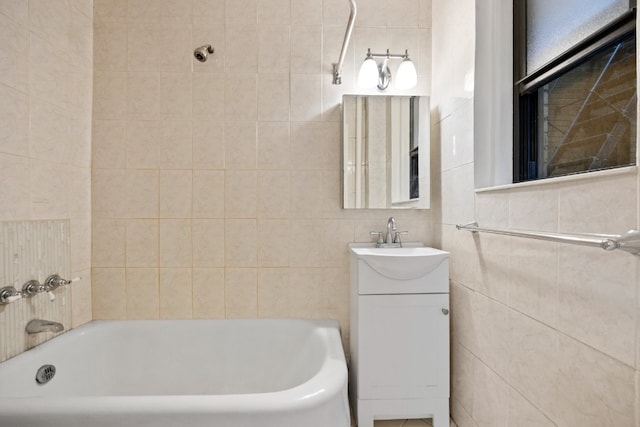 321 E 54th St Unit 2J, New York City, NY 10022 - bathroom with a bath, tile walls, and vanity
