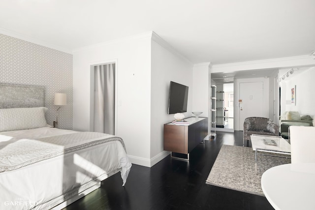 bedroom with wallpapered walls, baseboards, an accent wall, wood finished floors, and crown molding