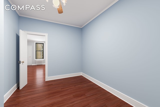 unfurnished room with dark wood-style floors, baseboards, and ornamental molding