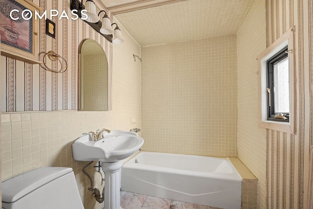 bathroom with toilet and wallpapered walls