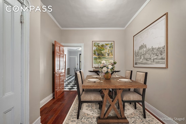 dining room featuring baseboards, dark wood-type flooring, and crown molding