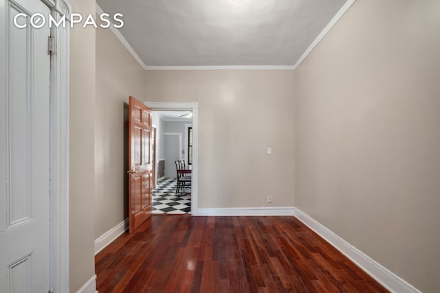 spare room with baseboards, dark wood-style floors, and ornamental molding