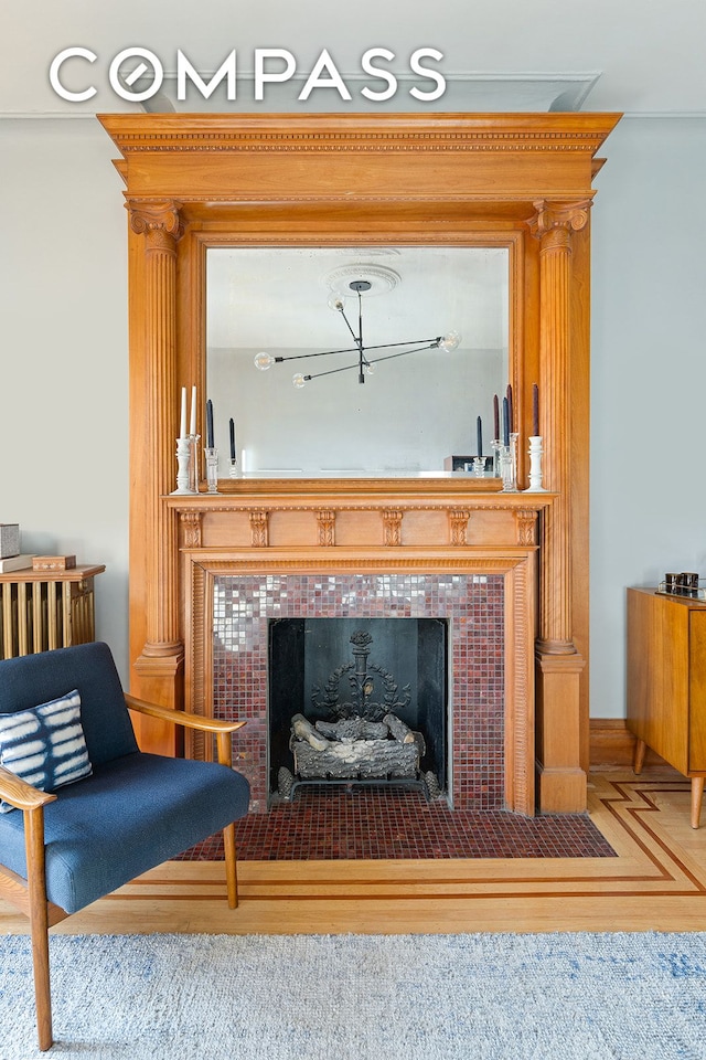 details with wood finished floors and a fireplace