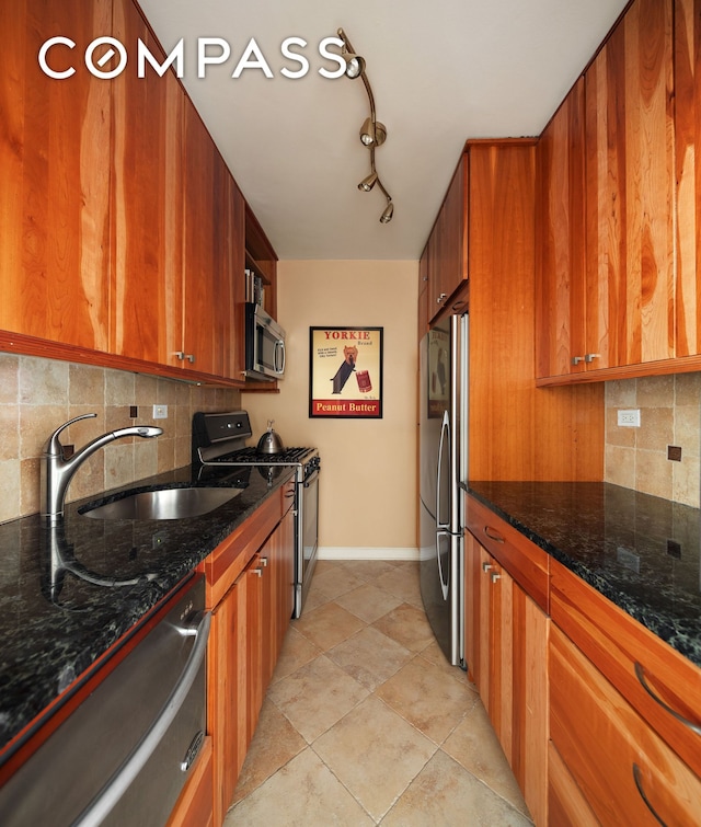 kitchen featuring a sink, brown cabinets, tasteful backsplash, and appliances with stainless steel finishes