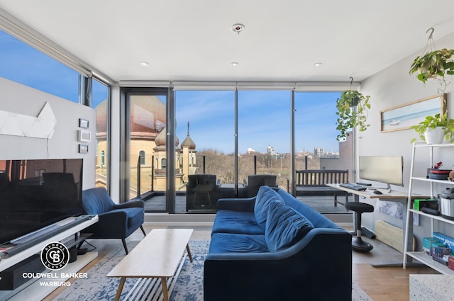 living room with expansive windows and wood finished floors