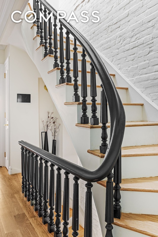 stairway featuring wood finished floors