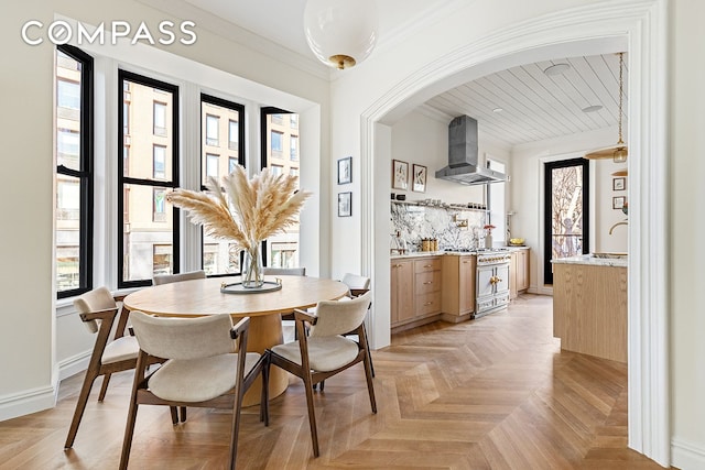 dining room with baseboards and crown molding