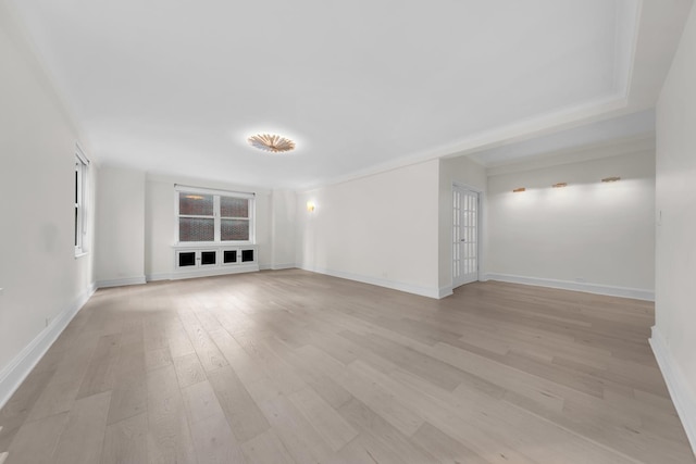 unfurnished room with light wood-type flooring and baseboards