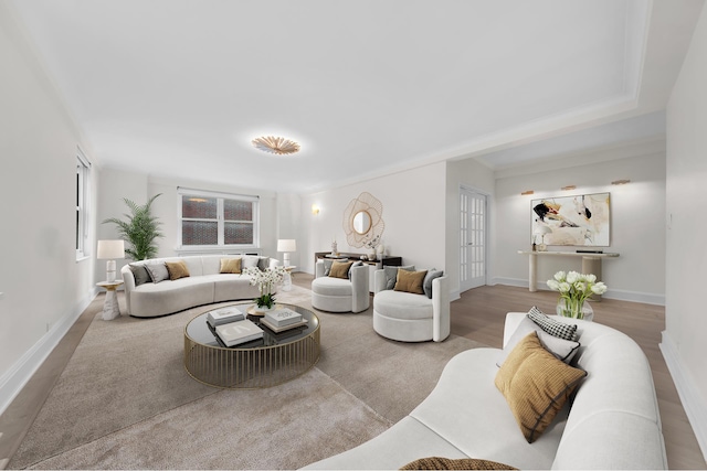 living area featuring baseboards, wood finished floors, and french doors