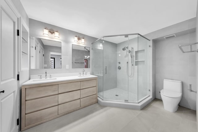 bathroom featuring a stall shower, visible vents, a sink, and double vanity