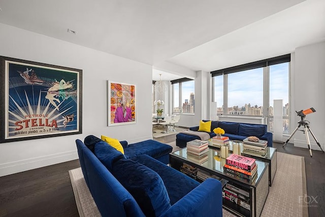 living room featuring wood finished floors, baseboards, and a view of skyline