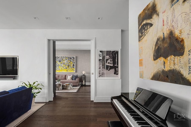 hall with dark wood finished floors and baseboards