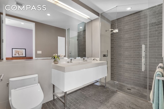 full bathroom featuring recessed lighting, a shower stall, toilet, and vanity