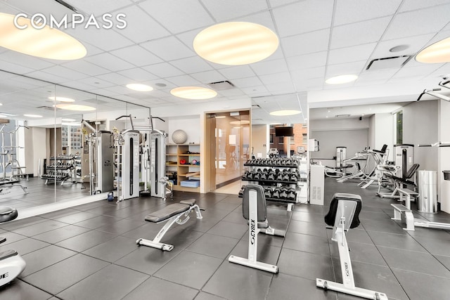 workout area with a drop ceiling and visible vents