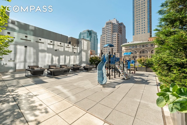 view of community with a city view, visible vents, playground community, and outdoor lounge area