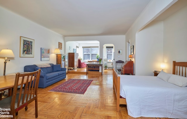 bedroom featuring arched walkways