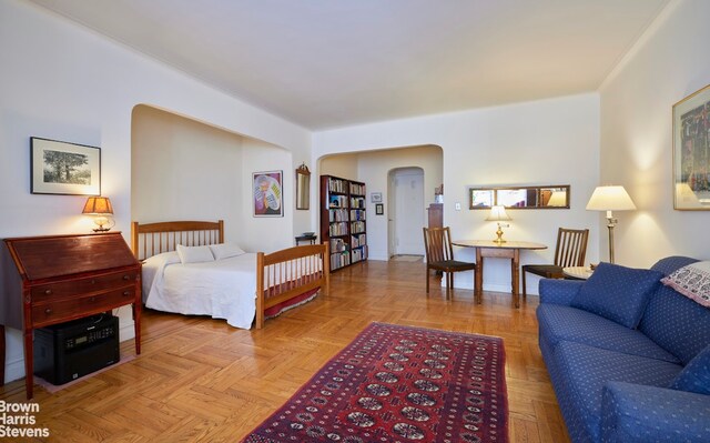 bedroom featuring arched walkways