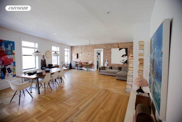 dining room featuring visible vents and brick wall