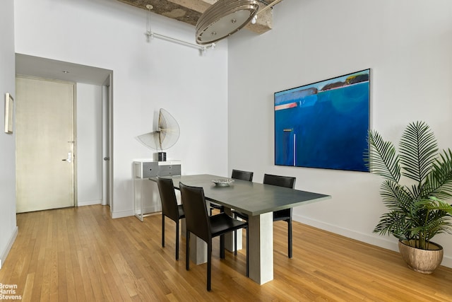 dining area with hardwood / wood-style floors and baseboards