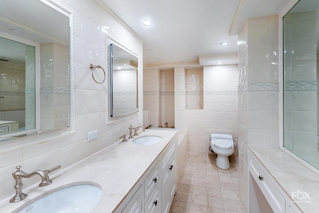 510 E 86th St Unit 14C, New York City, NY 10028 - full bathroom with tile walls, double vanity, toilet, and recessed lighting