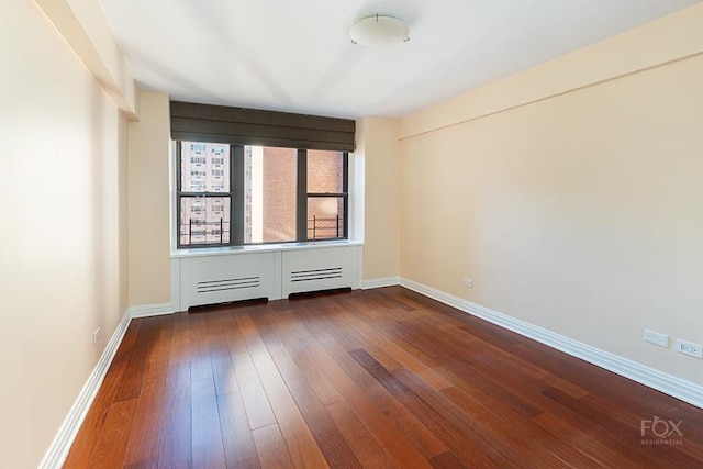 510 E 86th St Unit 14C, New York City, NY 10028 - empty room with dark wood-style floors and baseboards