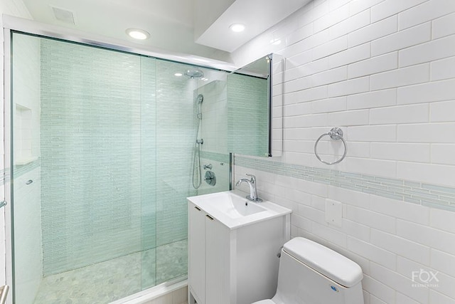 510 E 86th St Unit 14C, New York City, NY 10028 - full bath featuring tile walls, toilet, vanity, a shower stall, and recessed lighting