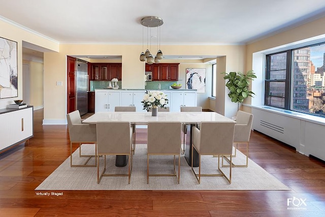 dining room with dark wood-style floors, baseboards, and crown molding