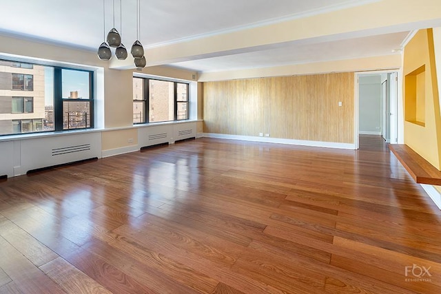 510 E 86th St Unit 14C, New York City, NY 10028 - unfurnished living room featuring a chandelier, wood finished floors, baseboards, and ornamental molding