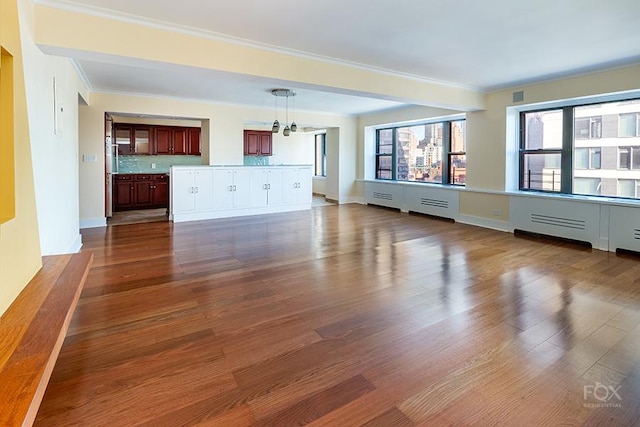 510 E 86th St Unit 14C, New York City, NY 10028 - unfurnished living room with dark wood-style flooring, a chandelier, crown molding, and baseboards