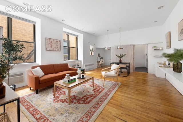 living room featuring visible vents and wood finished floors